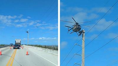 Un électricien installé sur un hélicoptère en stationnaire